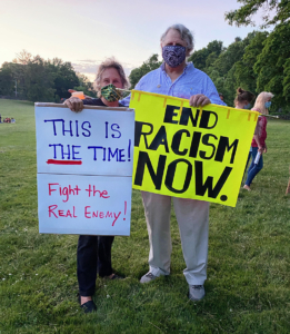 Tucker and R.L. Smith stand with their signs. (Photo by Alice Waugh)